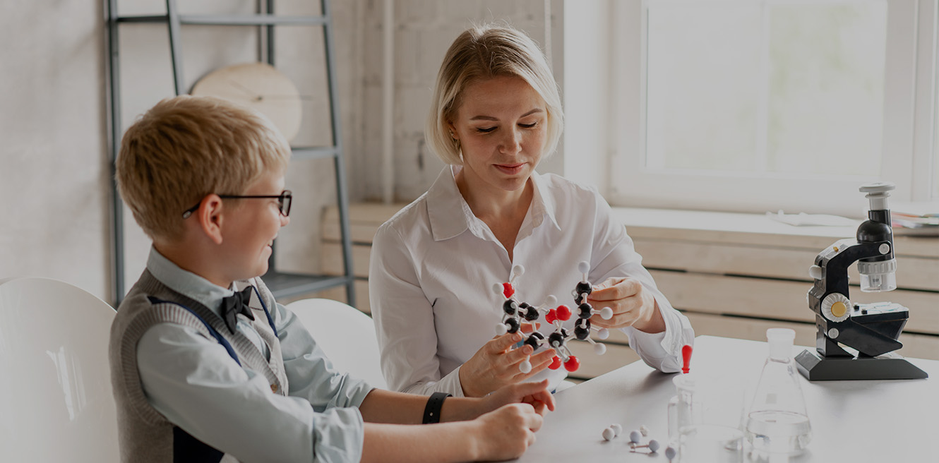 Female science tutor in San Diego studying chemistry with student